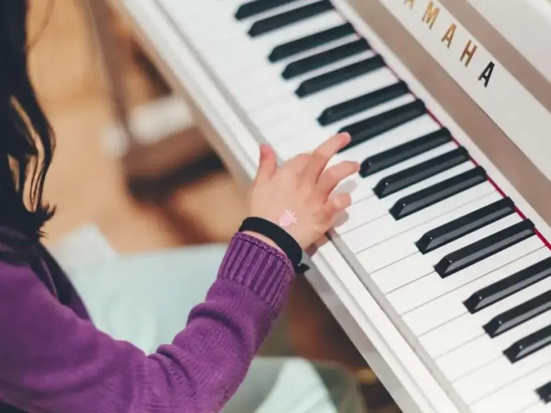 kid playing a piano